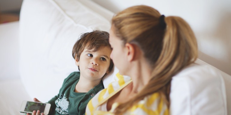Small boy talking to his mother