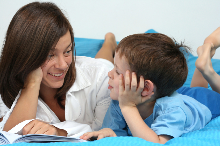 mother and five years old boy reading book - good night